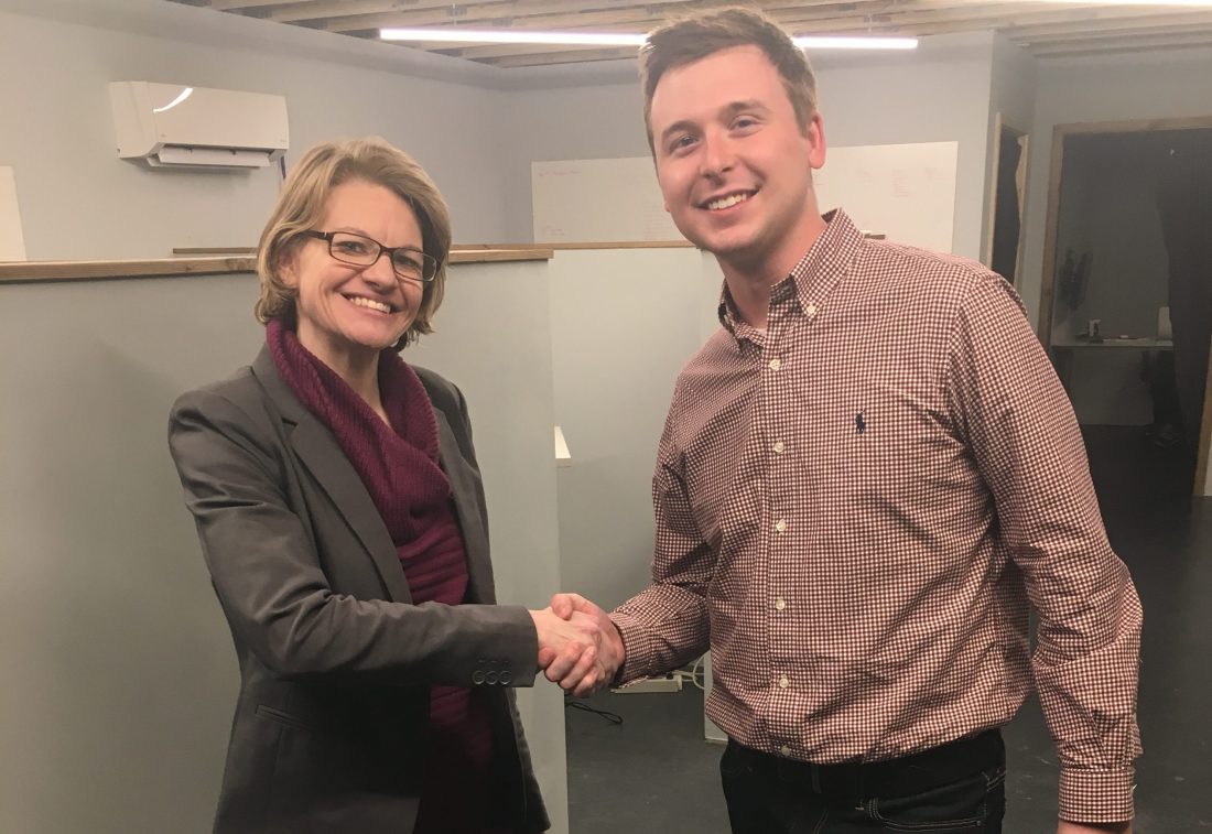 A man and a woman shake hands